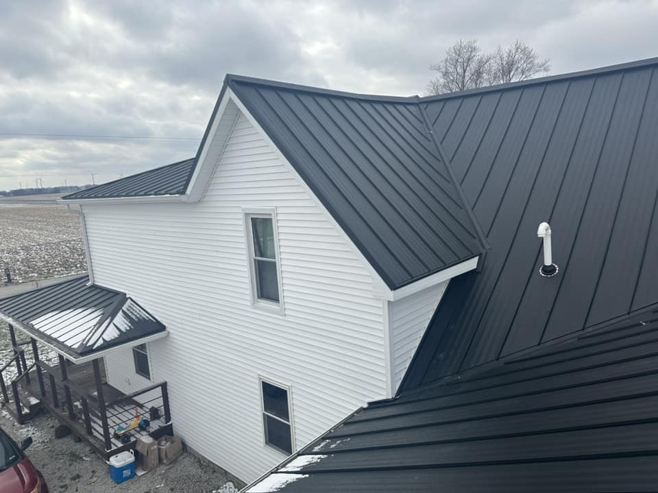House with blue siding on the snow field